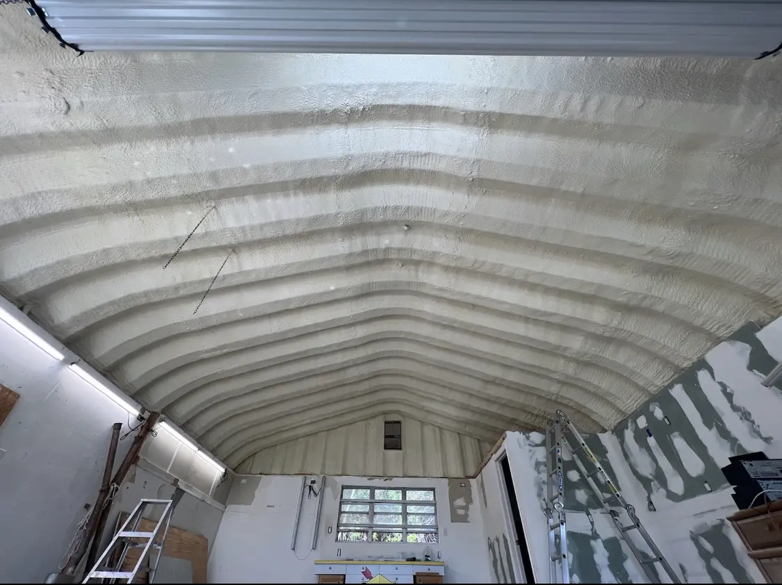 Spray polyurethane foam applied to the underside of a metal roof deck in Rolesville